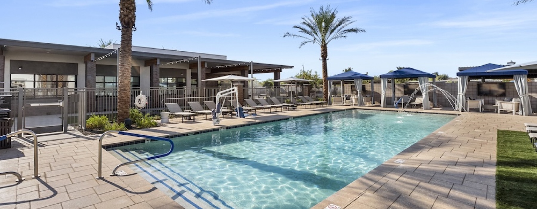 Resort-style swimming pool with lounge seating