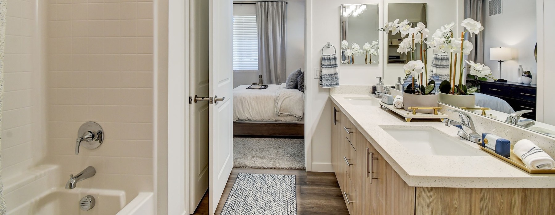 a bathroom with a tub, sink and mirror