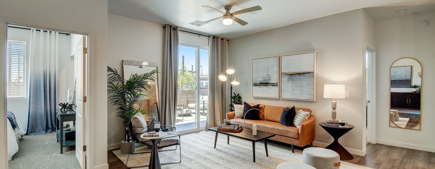 a living room with a large mirror and a couch